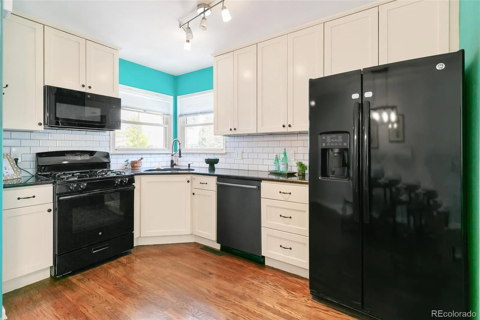 Kitchen with white cabinets and subway tile