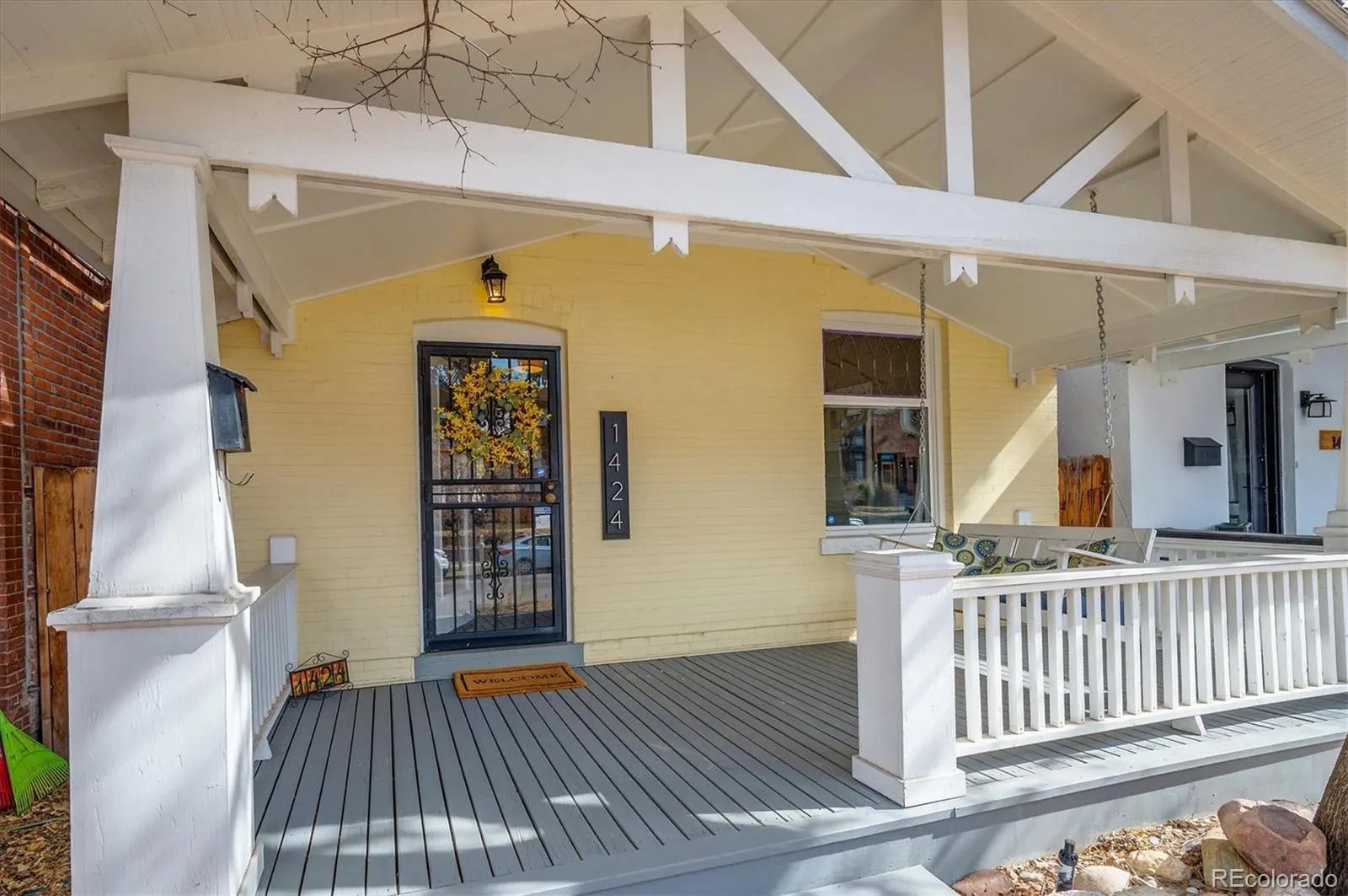 Covered front porch with white railing