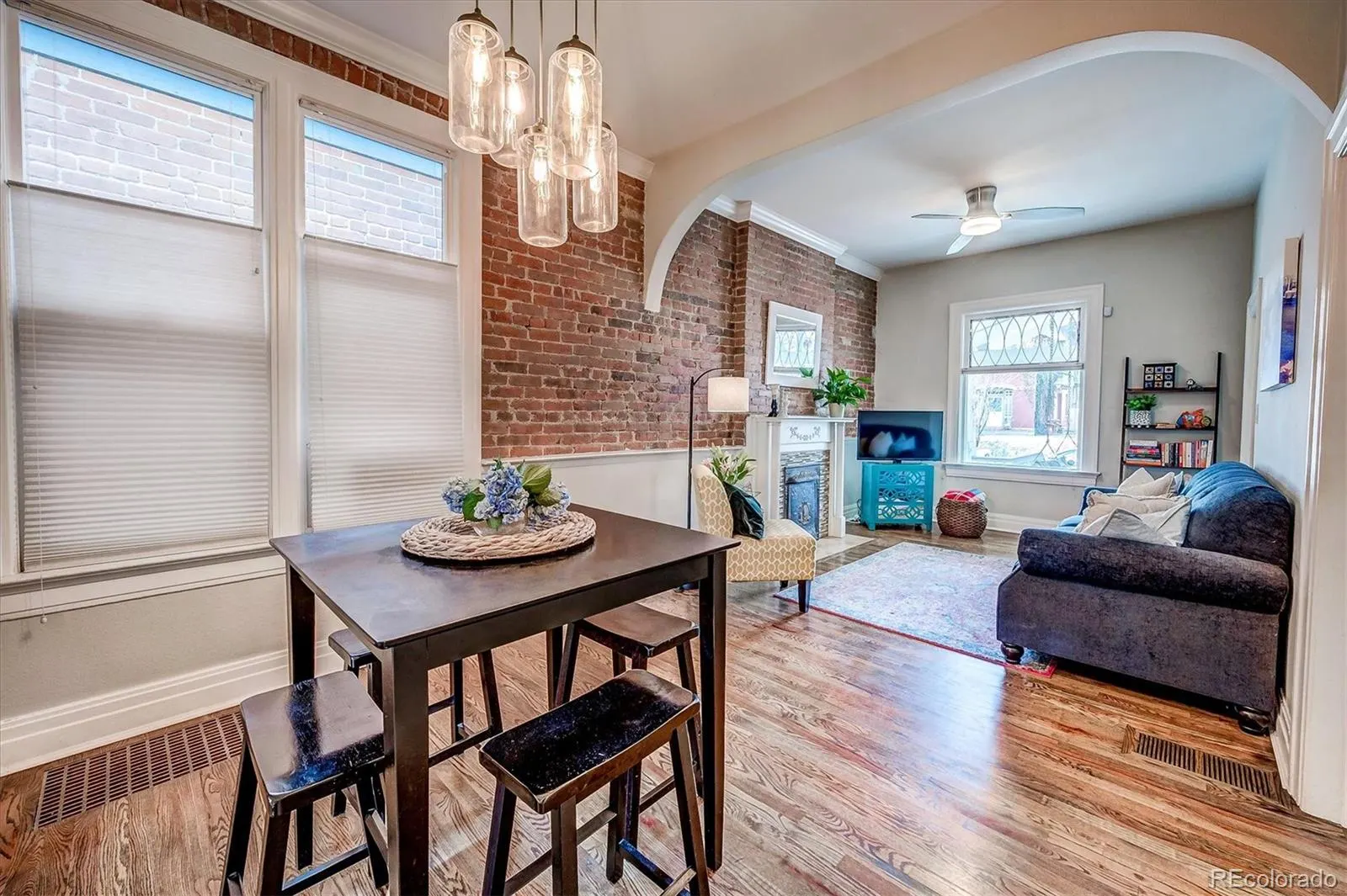 Dining area with exposed brick and pendant lights