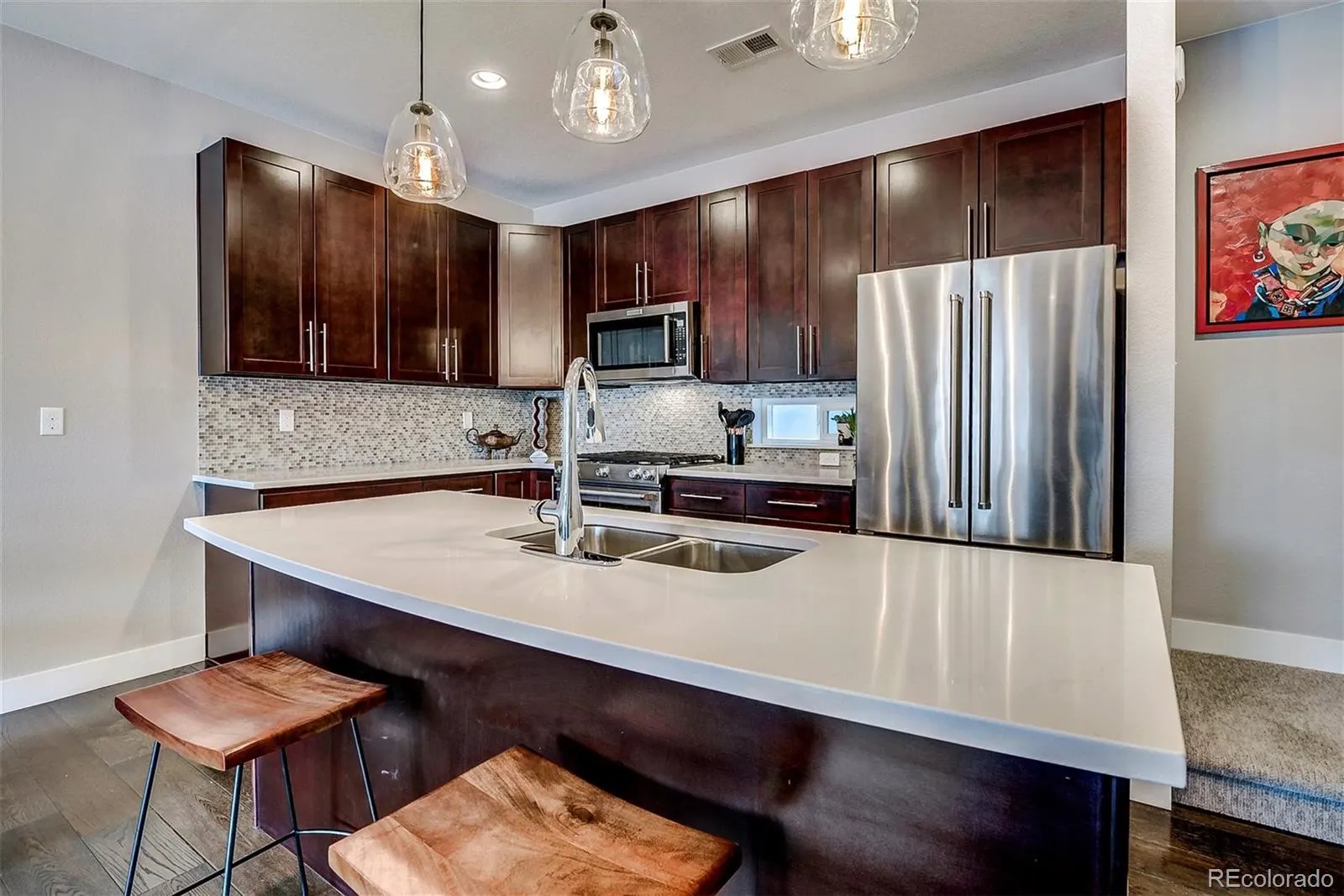 Kitchen with quartz island and dark cabinets