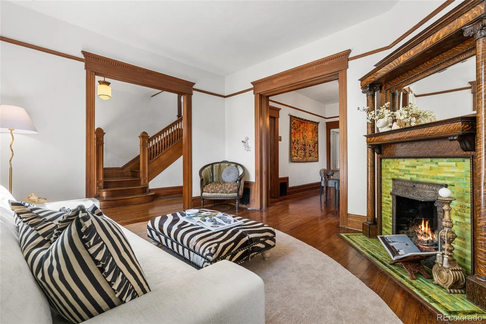 Living room with tiled fireplace and view to the staircase