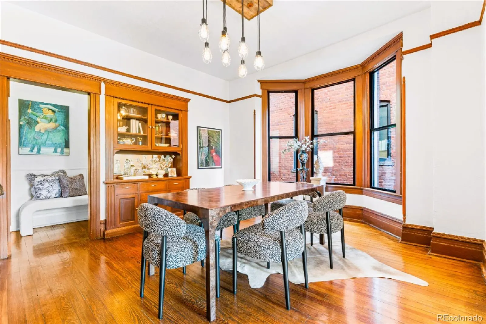 Dining room with built-in hutch and bay window