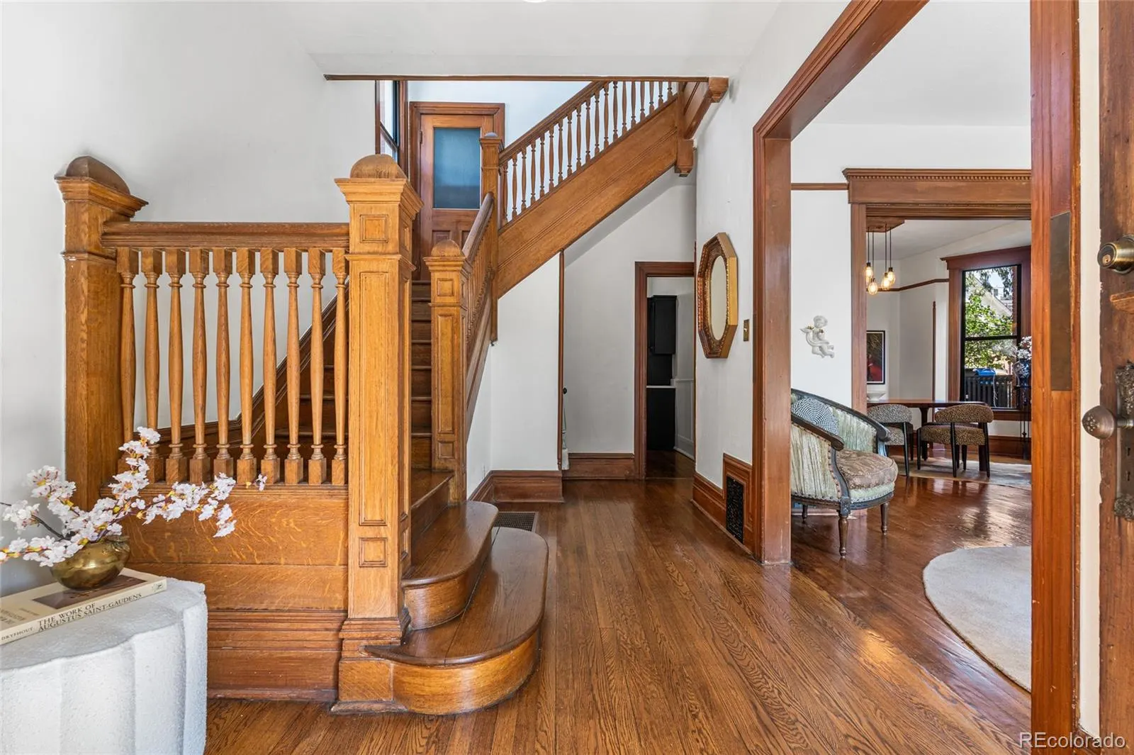 Staircase and entry hall with hardwood floors