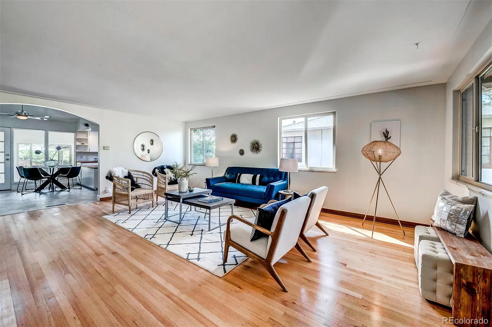 Open living room with oak floors and large windows