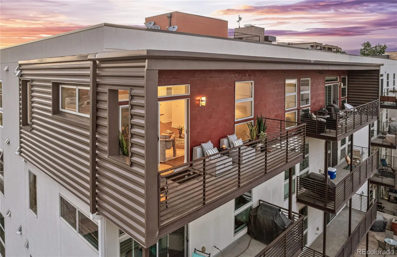 Top-floor corner unit and its wraparound deck at sunset