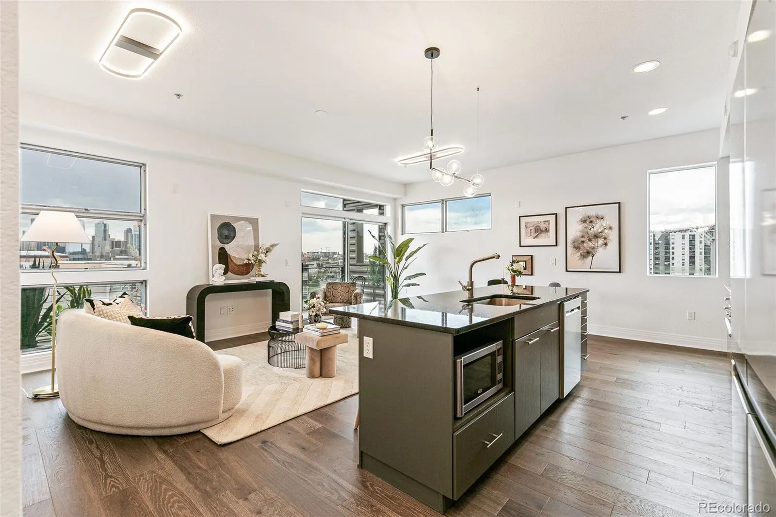 Open living room and island kitchen with city views