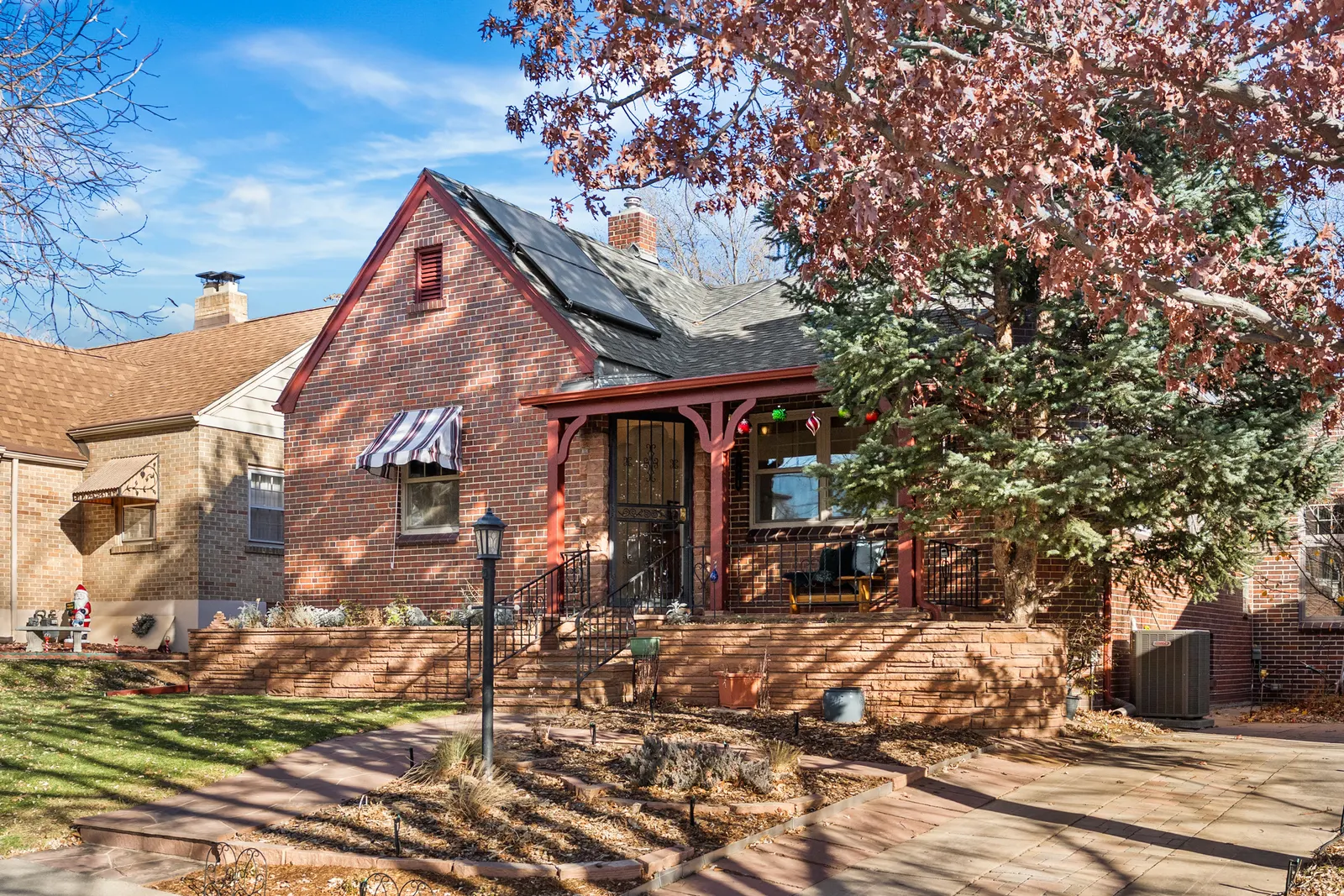 Tudor exterior under a red-leafed tree in fall