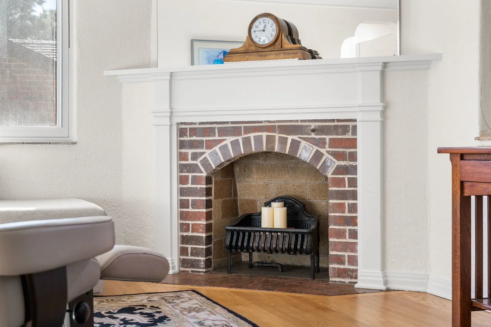 Original brick corner fireplace with white mantel