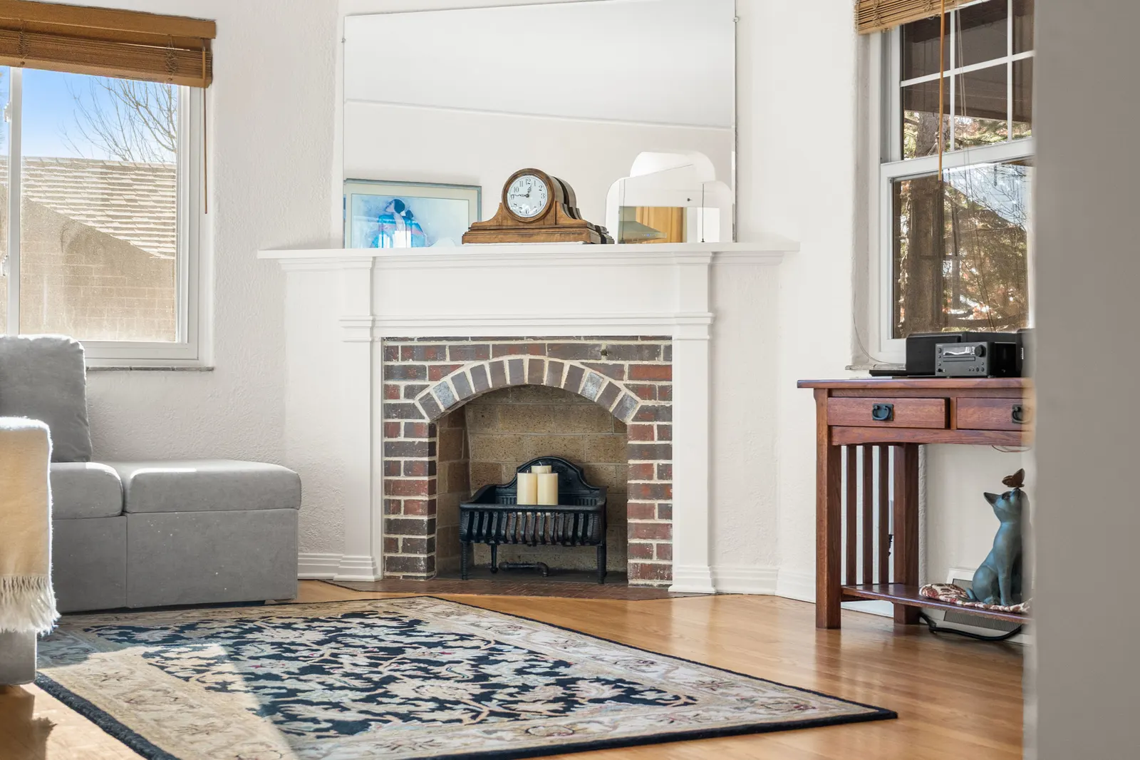 Living room fireplace beside a window with mountain light
