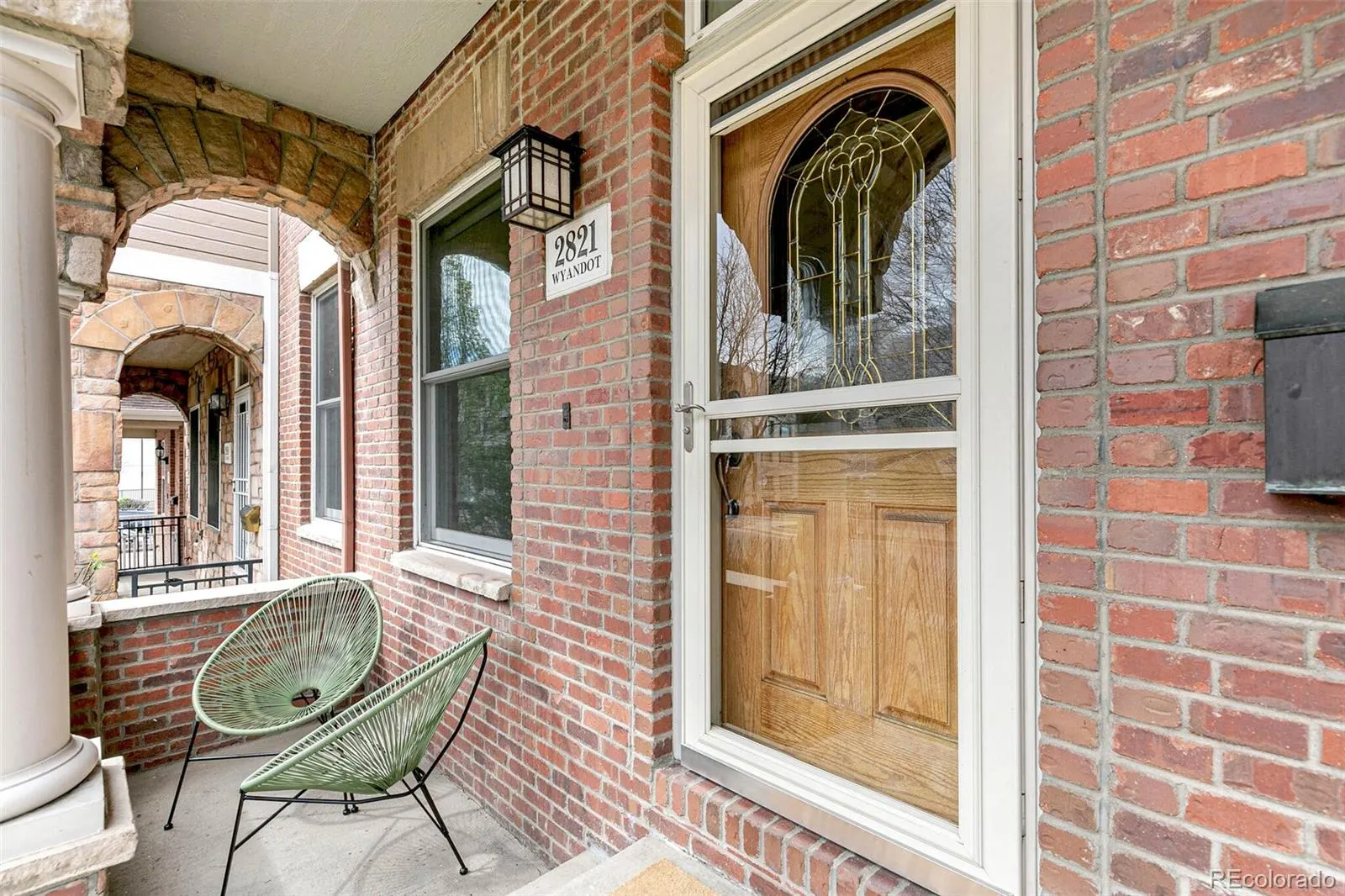 Covered front porch with stained-glass entry door