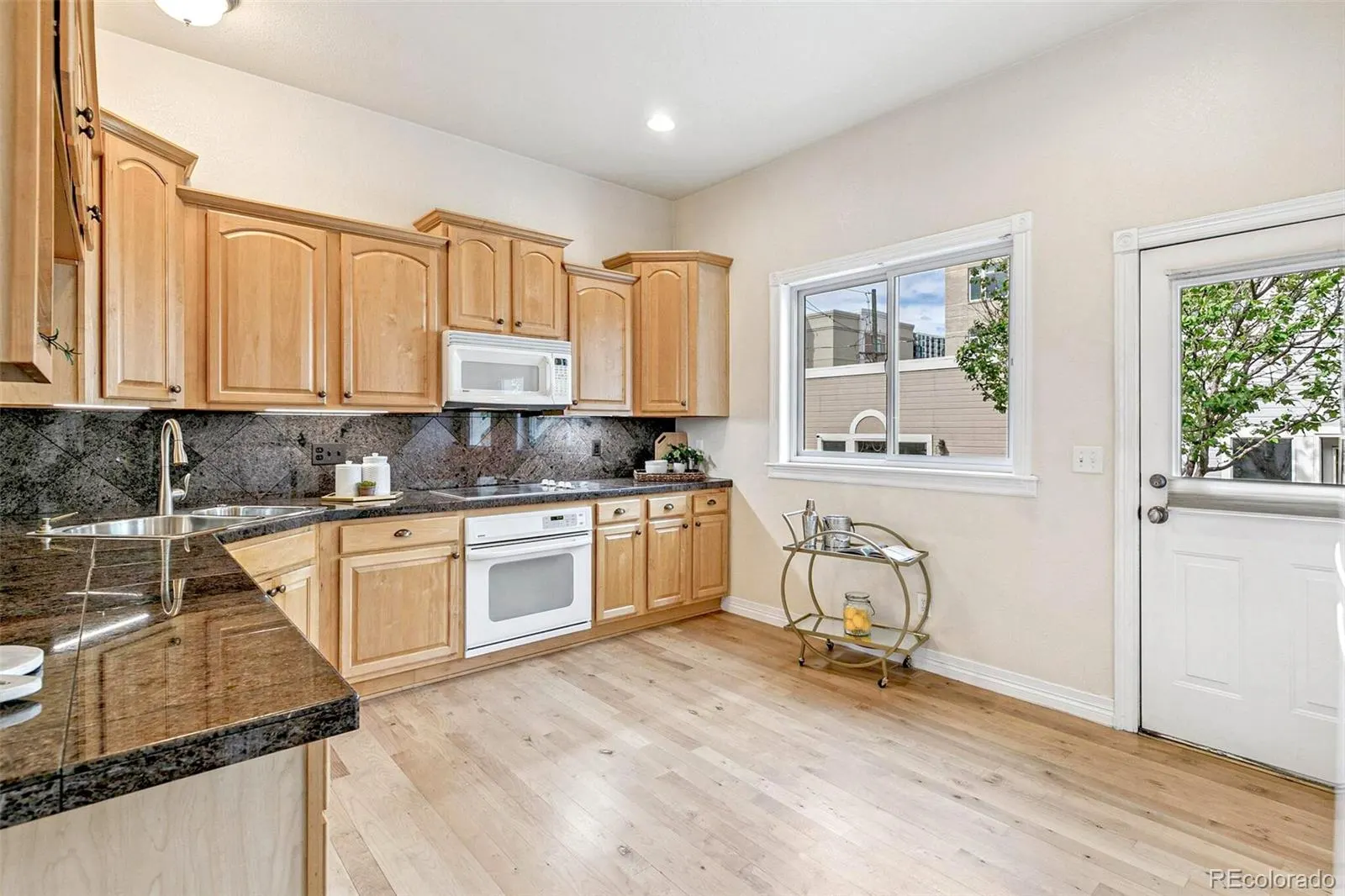 Kitchen with maple floors and wood cabinetry