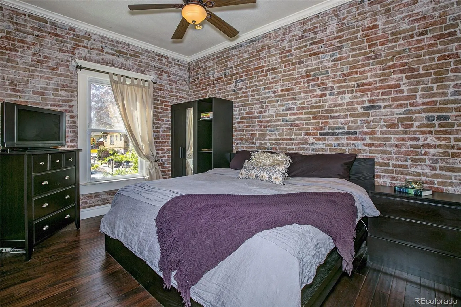 Bedroom with exposed brick wall