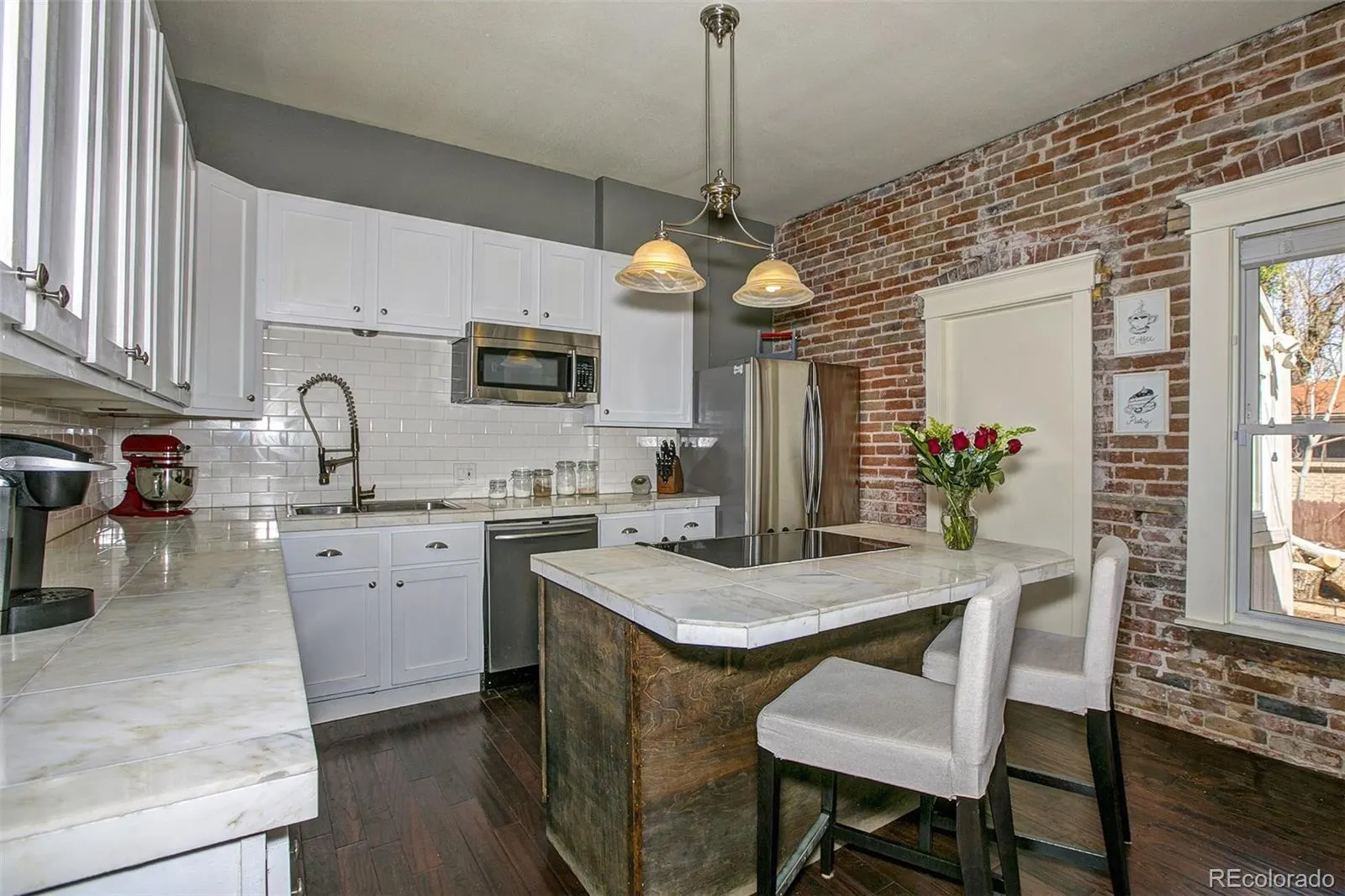 Kitchen with island and exposed brick