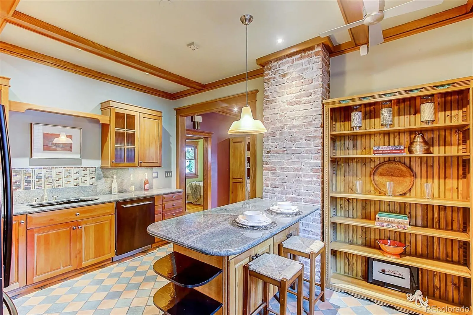 Kitchen with exposed brick and marble island