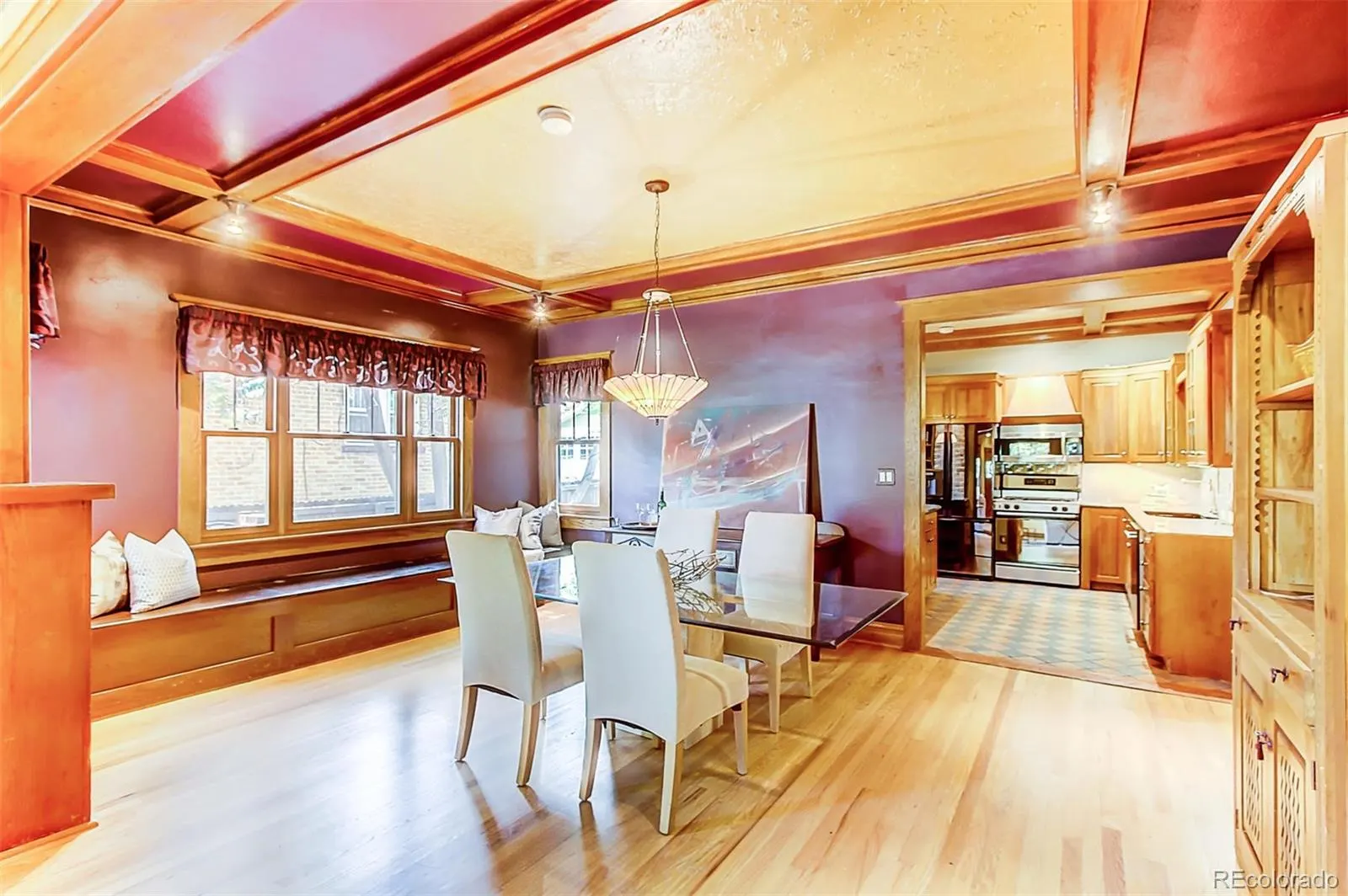 Dining room with built-in bench under a triple window