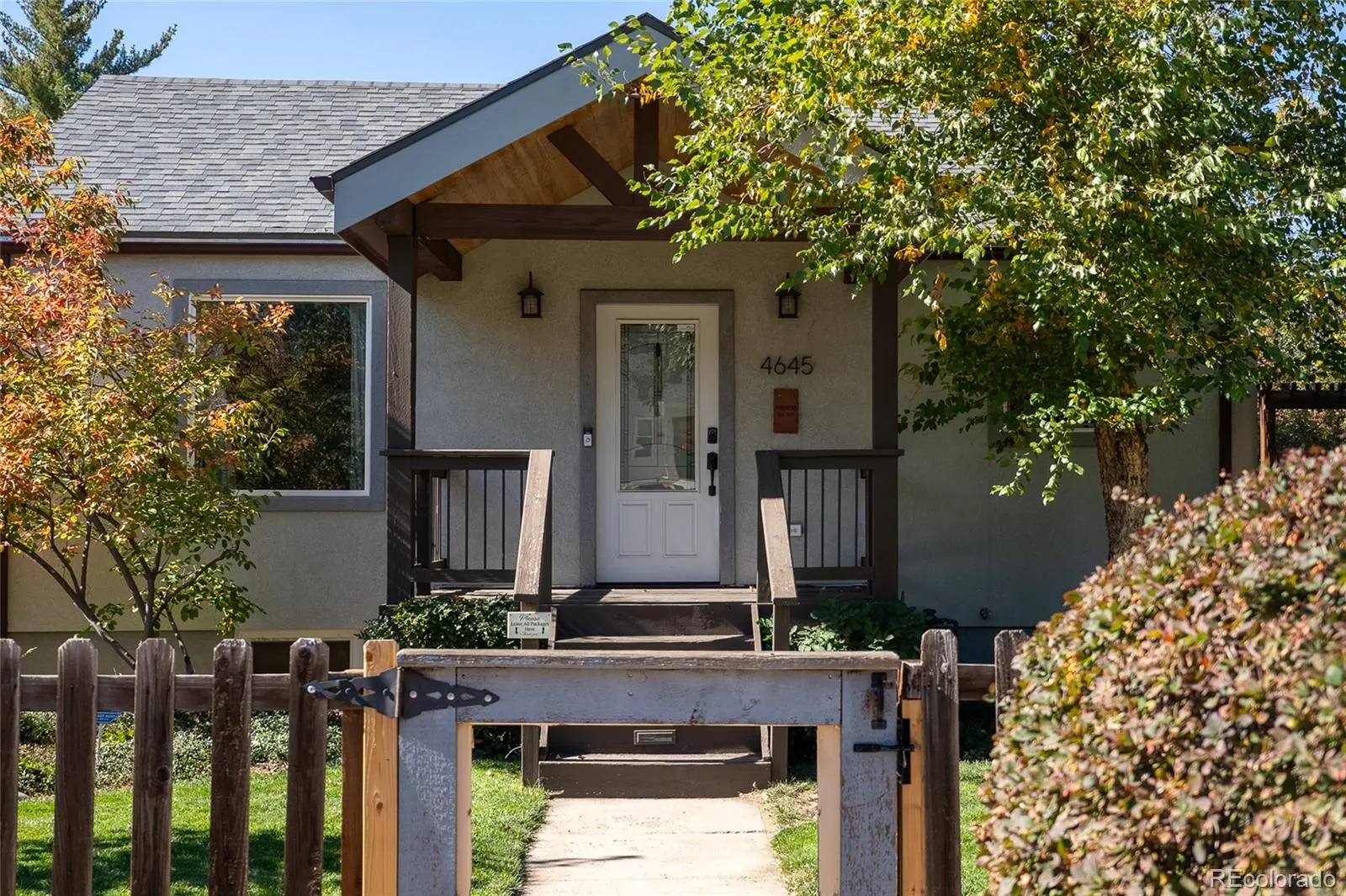 Front porch behind a low wooden fence