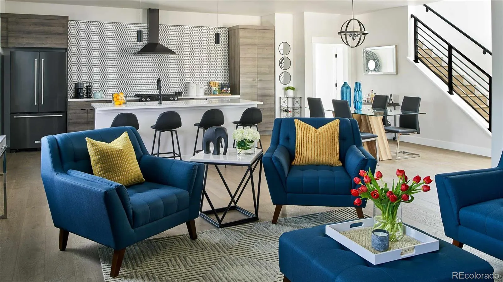 Living room with blue armchairs and open kitchen
