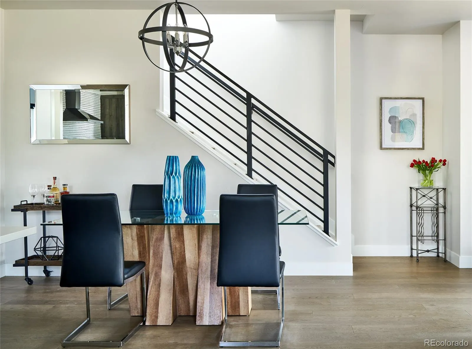 Dining area beneath the open-rail staircase