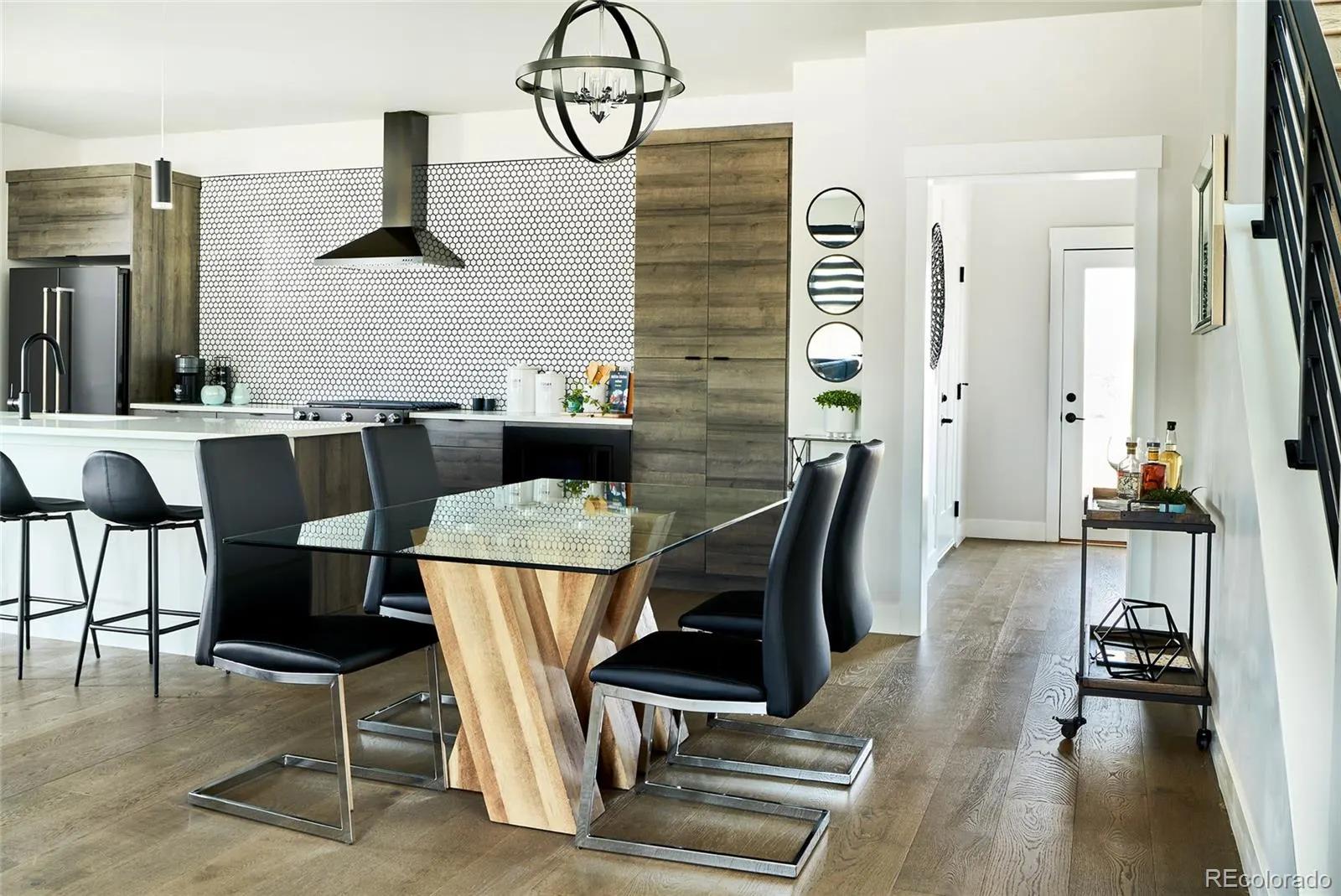 Kitchen with black range hood and dining