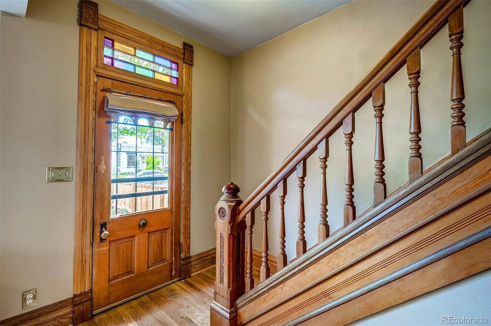Stained-glass front door and original staircase