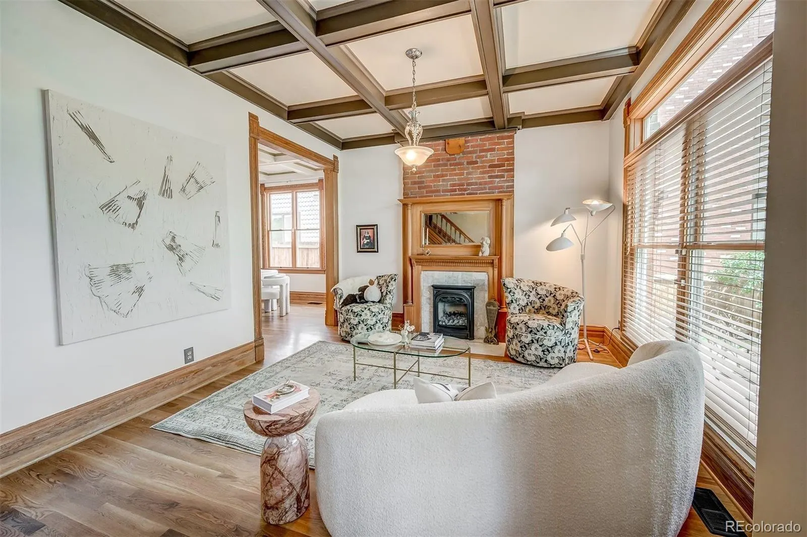 Living room with coffered ceiling and brick fireplace