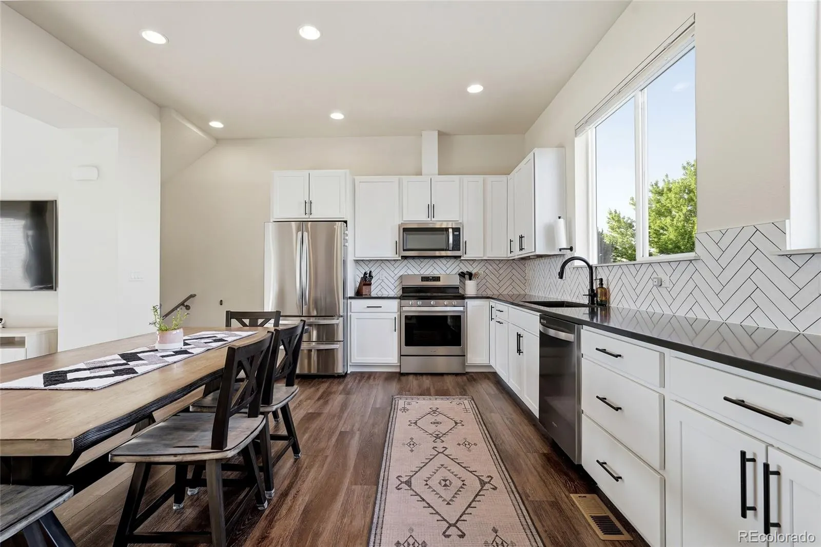 Dining and kitchen with large windows