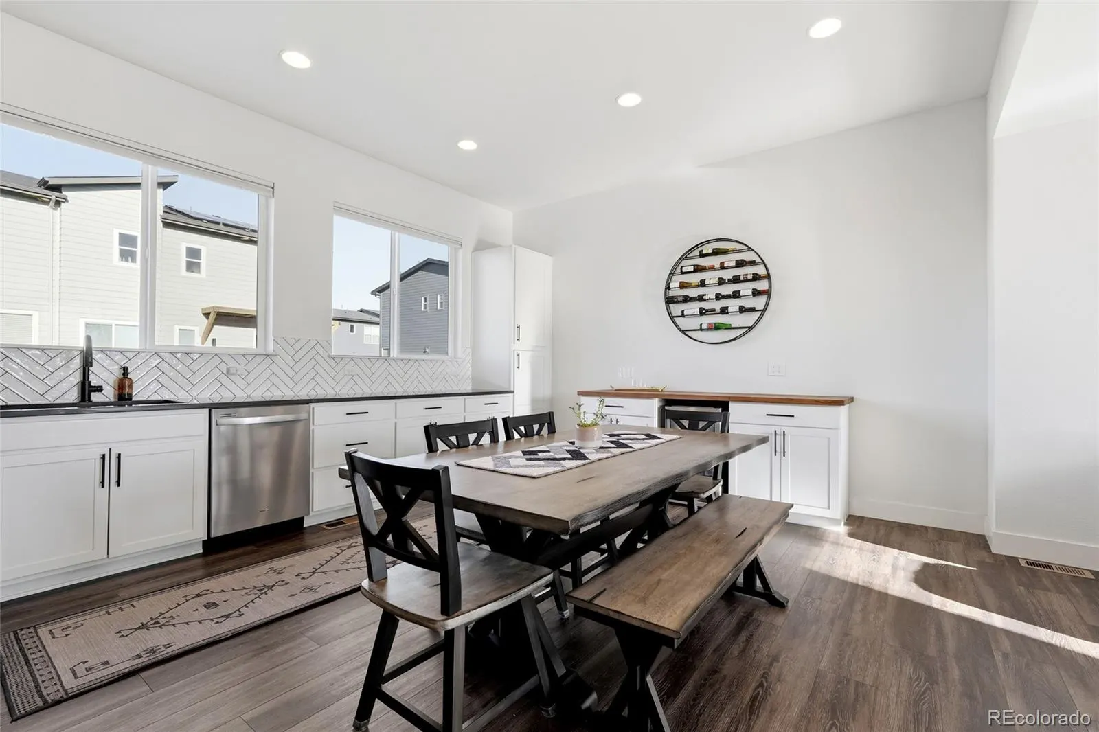 Open main level with ten-foot ceilings, dining table and kitchen